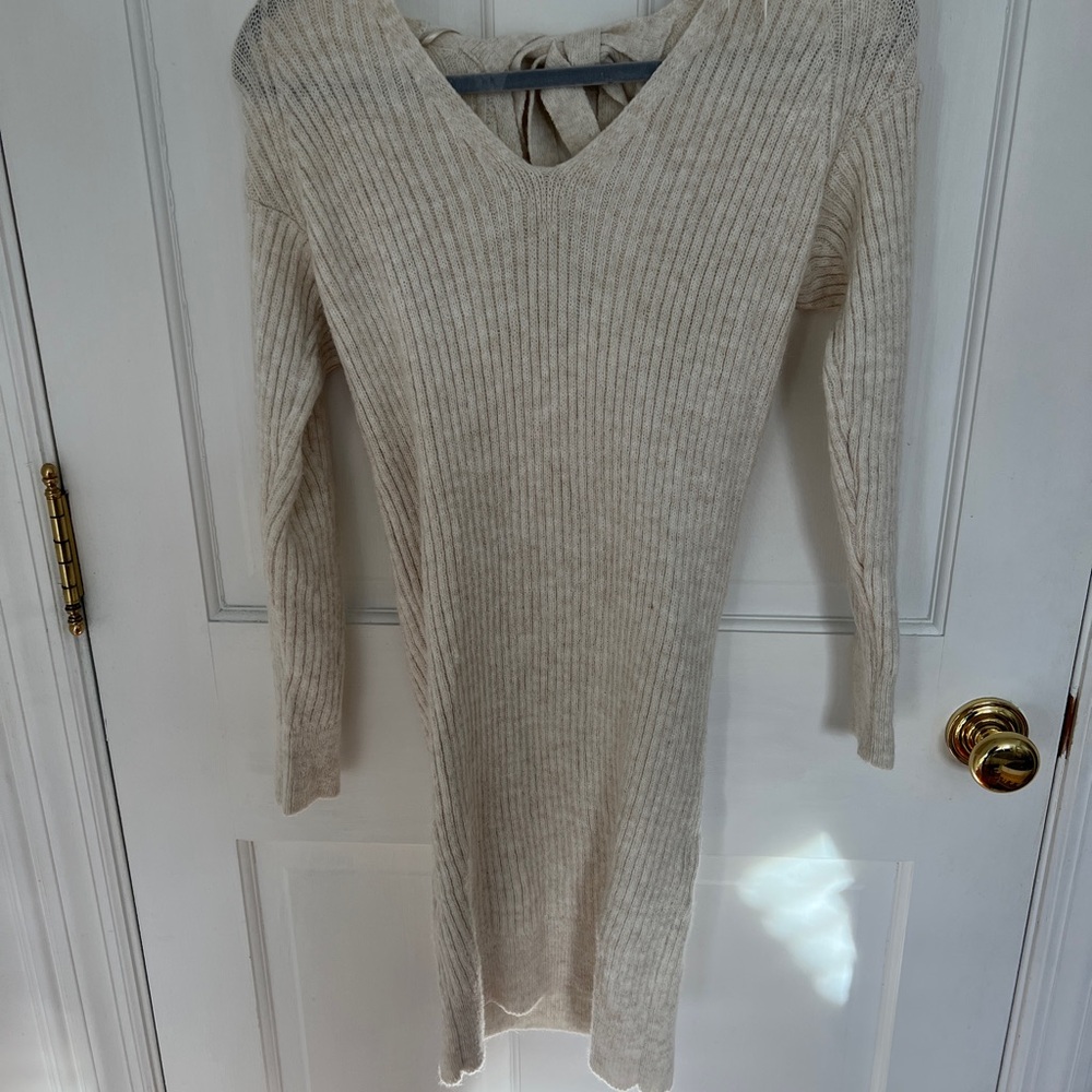 Super cute and cozy sweater dress with a cut out and bow in the back